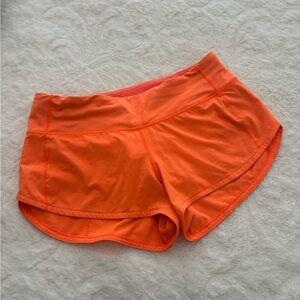 Lululemon 2.5 speed up neon orange shorts